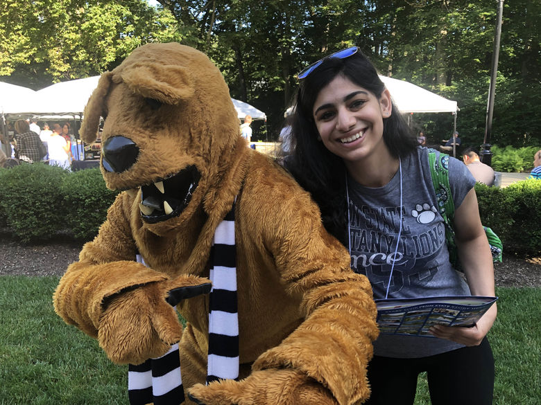 Student and Nittany Lion smiling for photo