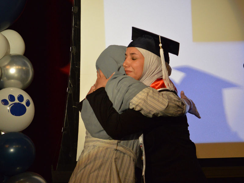 Student and a loved one on stage