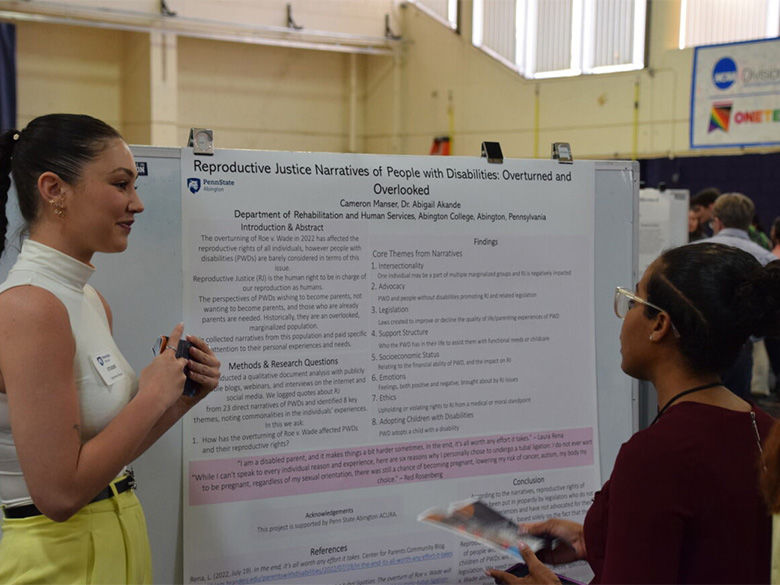 student presenting poster at ACURA fair