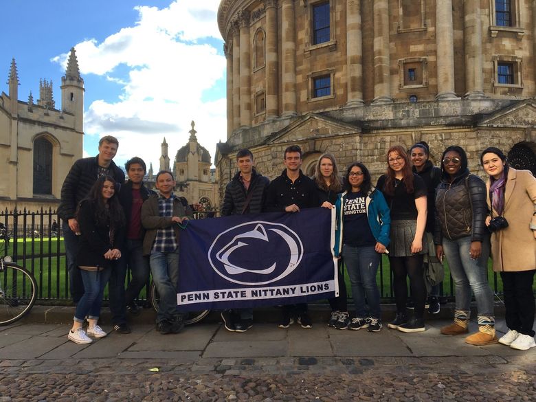 Group of students holding Penn State Flag in England 