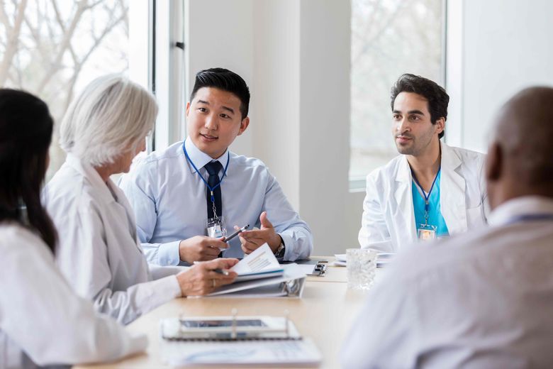 students and doctors talking at a table