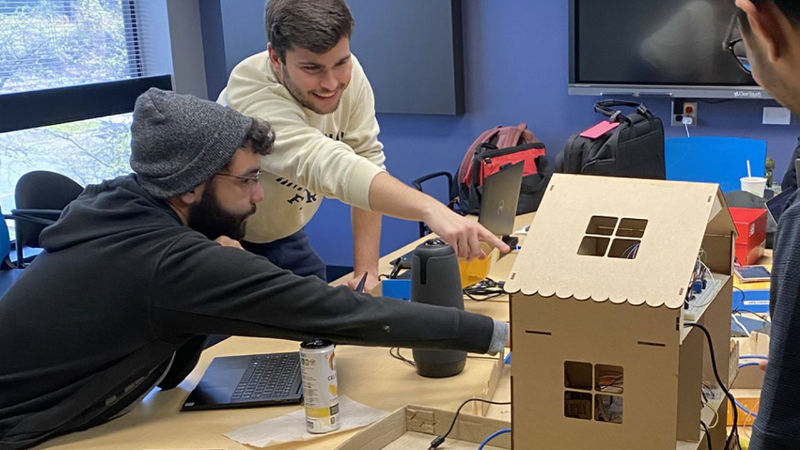 Students in a conference room working on a project