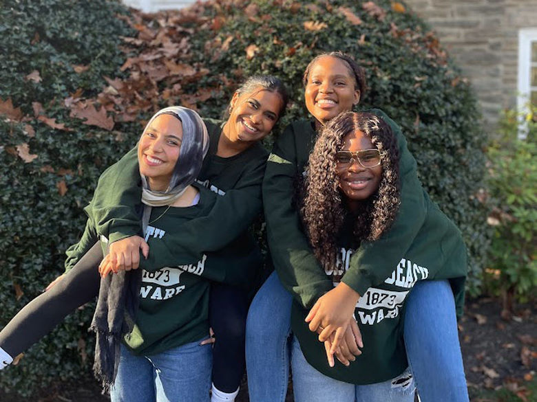 four students smiling at Penn State Abington (near Philadelphia)