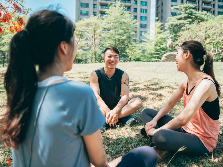 students sitting in the grass talking