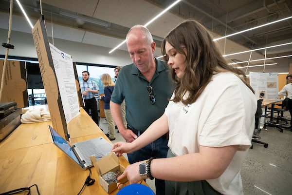 student and a adult looking at her computer screen