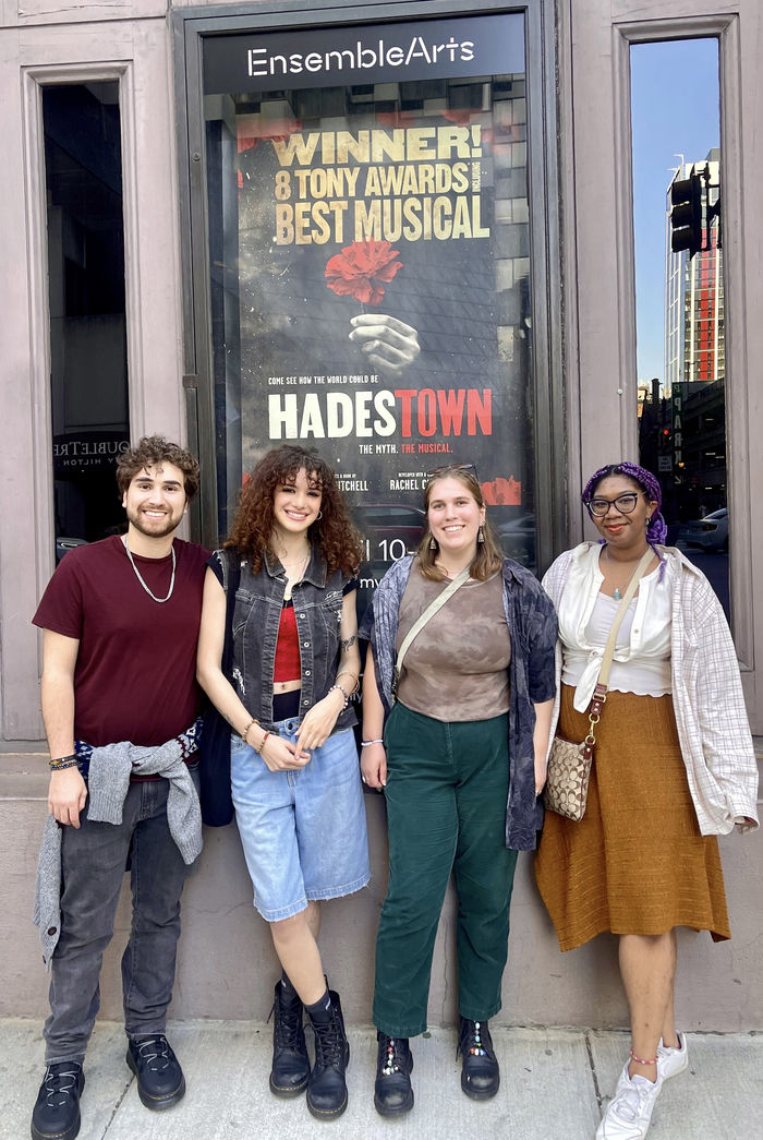 students standing in front of theatre