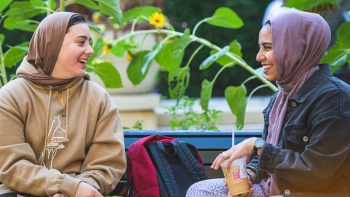 Students talking on bench