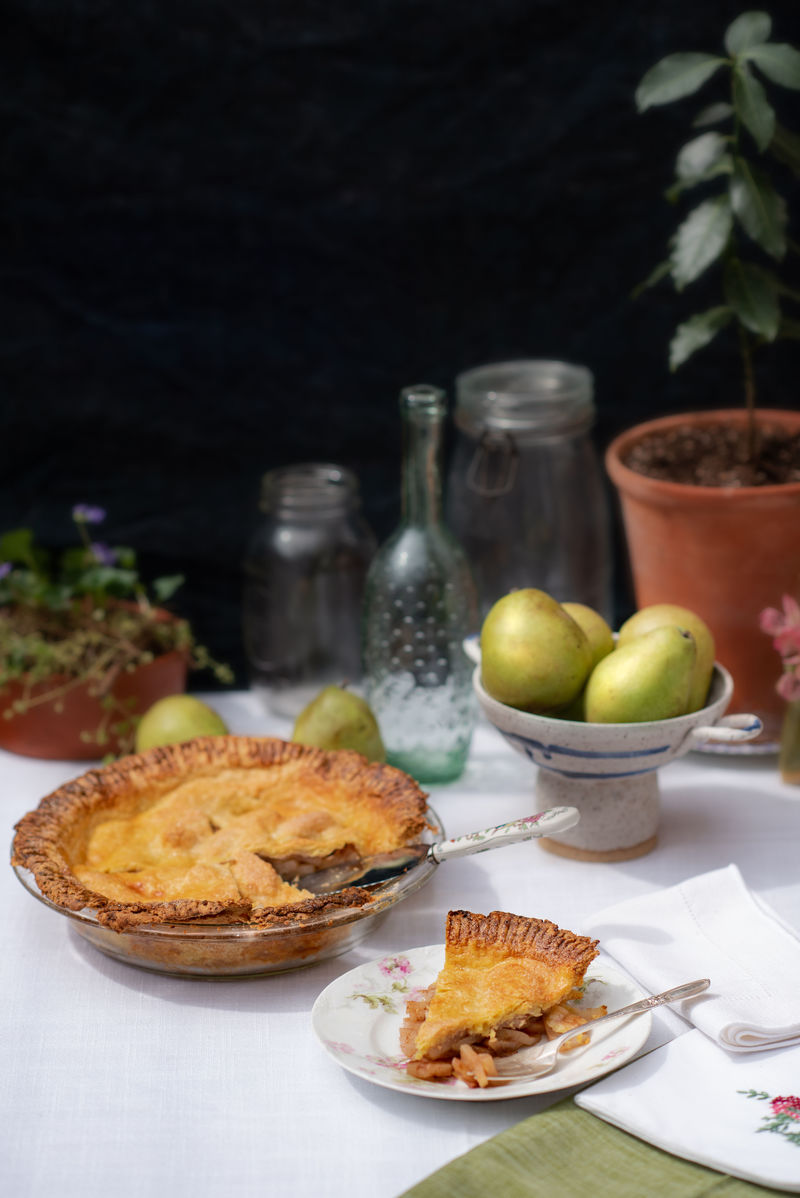 Pear pie with a slice cut on a plate