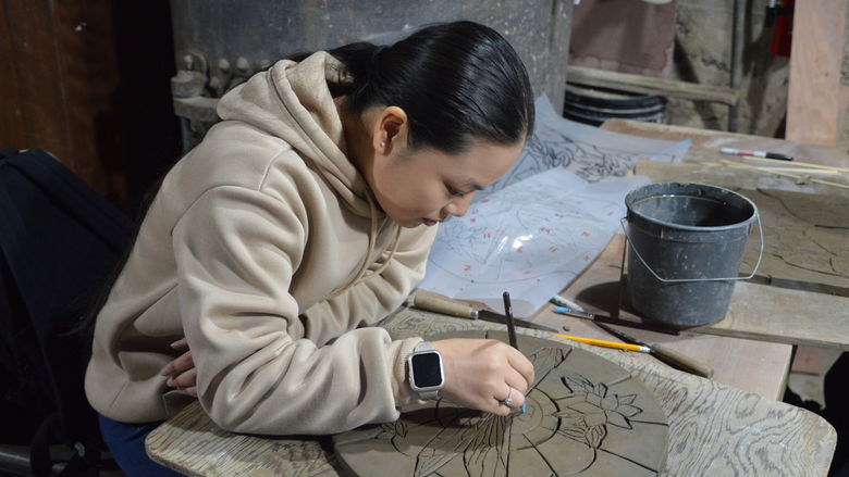 Woman creating a tile