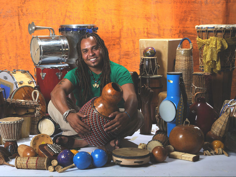 Man surrounded by percussion instruments