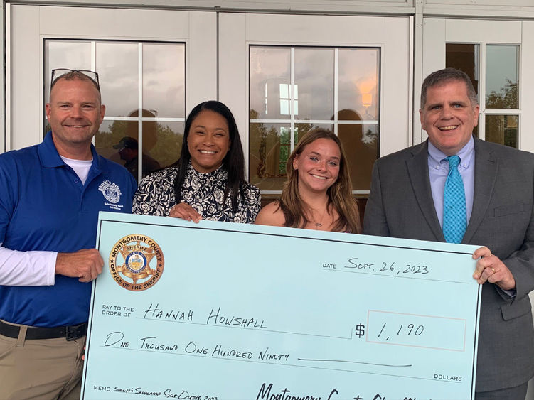 Montgomery County Sheriff's Office Chief Deputy Adam Berry, county Commissioner Jamila Winder, student Hannah Howshall, and Sheriff Sean Kilkenny with Hannah's scholarship check